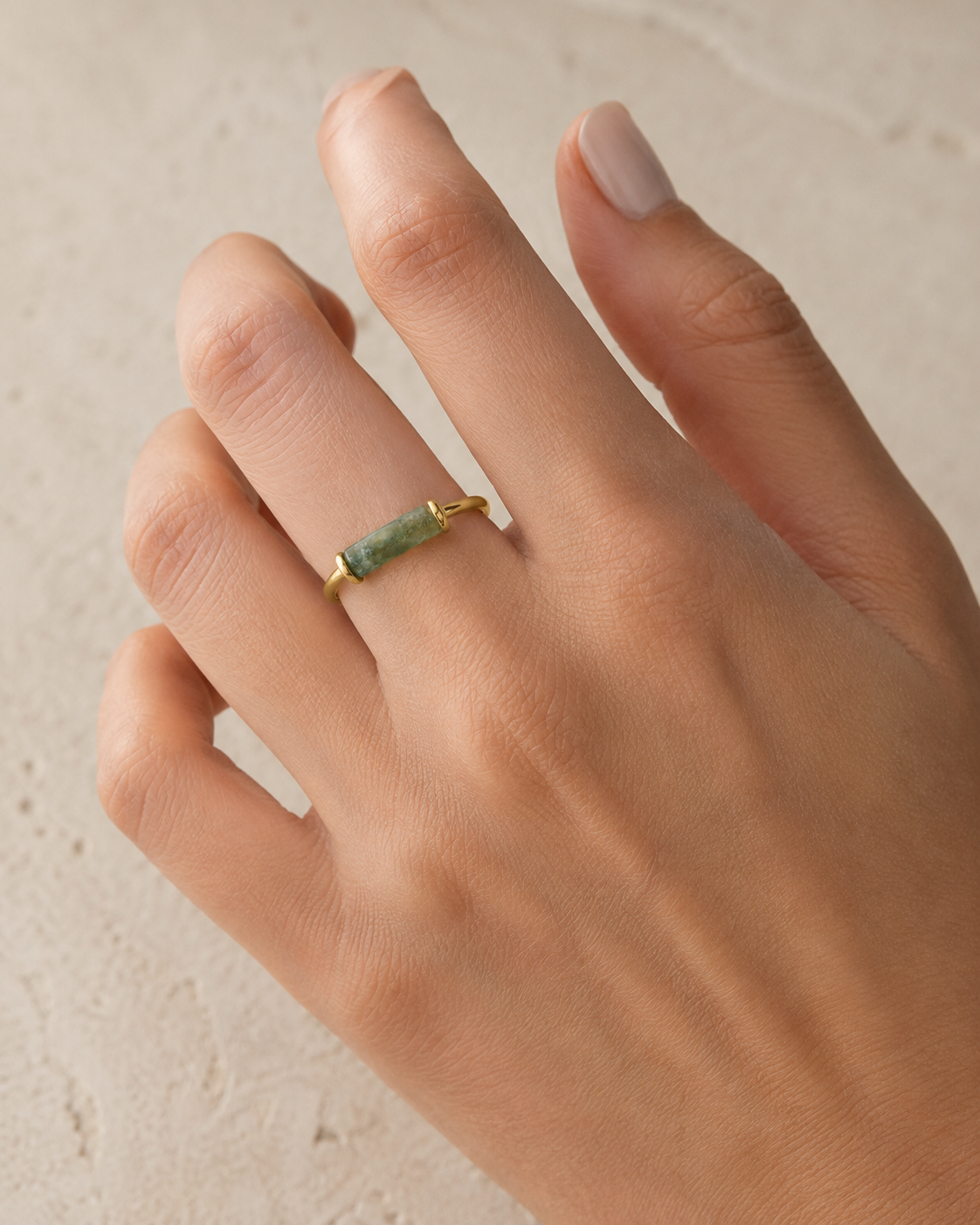 Hand wearing the ring, the Roman vitrum and its two gold retainers in view